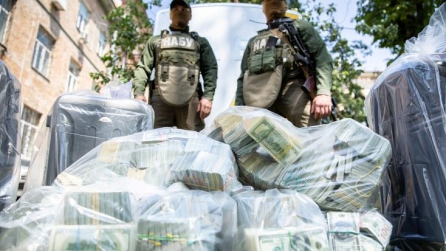  officers_of_the_national_anti-corruption_bureau_of_ukraine_stand_next_to_plastic_bags_filled_with_seized_u.s._dollar_banknotes_in_kievofficers_of_the_national_anti-corruption_bureau_of_ukraine_stand_next_to_plastic_bags.jpeg 
